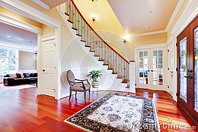 Luxury home entrance with cherry hardwood floor and staircase.