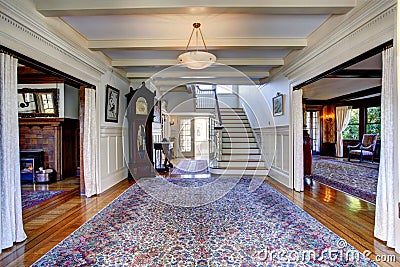 Luxury house. Hallway with rug and staircase