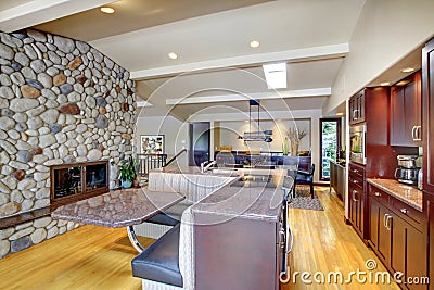 Luxury mohogany Kitchen with modern furniture and stone fireplace.