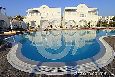 Luxury resort white villas over blue pool water