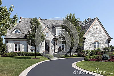 Luxury stone home with circular driveway