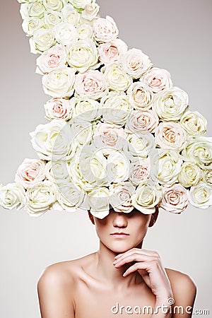 Luxury woman with a rose hat in fashion model pose