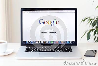 MacBook Pro Retina with Google home page on the screen stands on