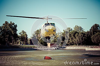 MADRID, SPAIN - AUGUST 3 : Fire rescue heavy helicopter with water bucket, goes to a fire in Madrid on August 3, 2013, Spain.