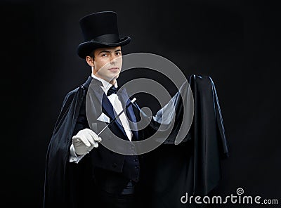 Magician in top hat with magic wand showing trick