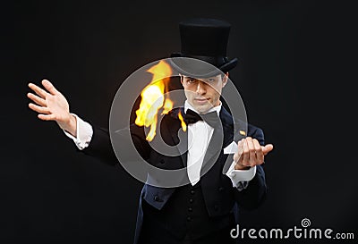 Magician in top hat showing trick with fire