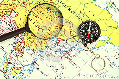 Magnifying glass , a compass and a map