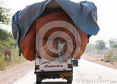 Mahindra pickup truck overloaded.