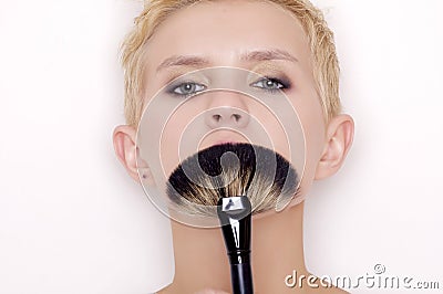 Make-up artist holding brushes