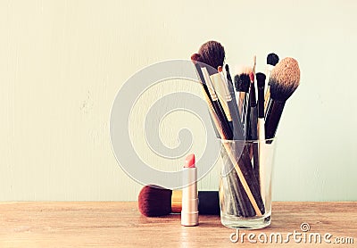 Make up brushes over wooden table