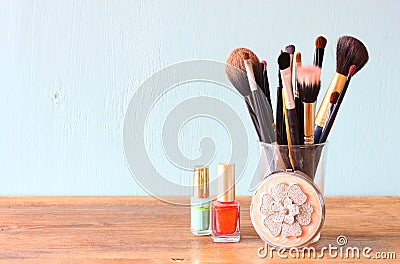 Make up brushes over wooden table pic