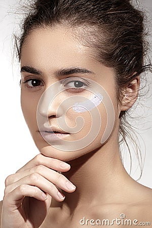 Make-up & cosmetics. Beautiful model with clean skin, foundation concealer cream