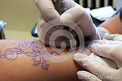 Making tattoo on left forearm, sketchout visible