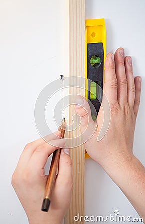 Making wall markings using a spirit level and pencil