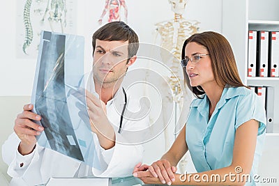Male doctor explaining spinexray to female patient