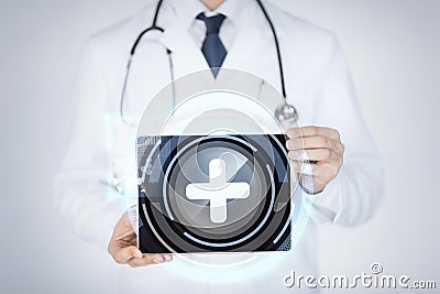 Male doctor holding tablet pc with medical app