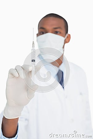 Male doctor in mask and glove holding an injection