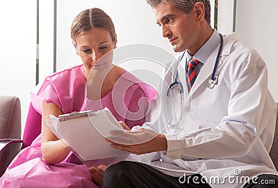 Male doctor showing medical exams to his patient woman