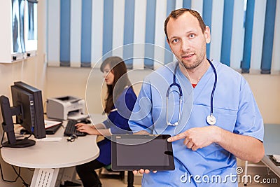 Male doctor using a tablet computer in a hospital.