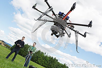 Male Engineers Operating UAV Helicopter
