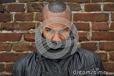 Male fashion model with scarf covering face