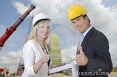 Male and female architect and construction site