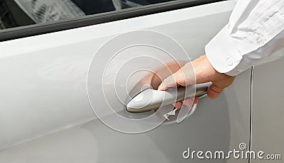 Male hand in shirt opening car door