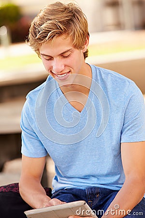 Male High School Student Using Digital Tablet Outdoors