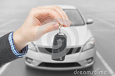 Male holding car keys with remote control system