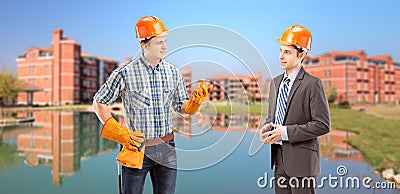 Manual worker having a conversation with architect, buildings in