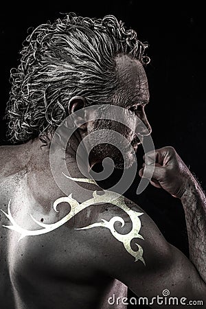 Male model with tribal tattoo, evil, blind, fallen angel of deat