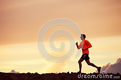 Male runner silhouette, running into sunset