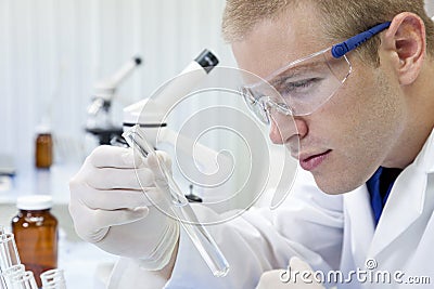 Male Scientist With Test Tube In Laboratory