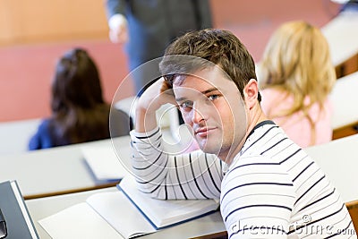 Male student attending a class at the university