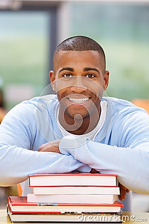 Male Student Studying In Classroom With Books