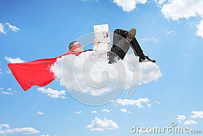 Male superhero lying on cloud and reading a newspaper