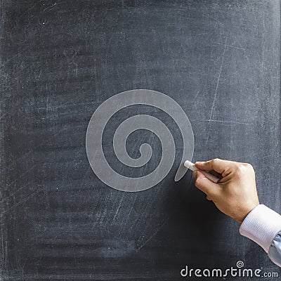 Male teacher hand holding white chalk