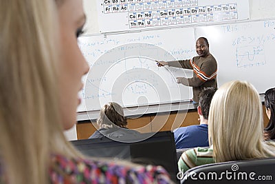 Male Teacher Teaching Students In The Classroom