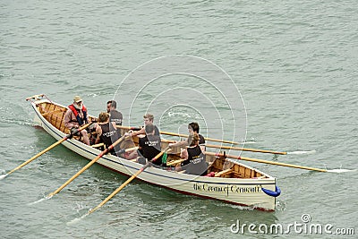 Male team on rowing boat at Clovelly, Devon