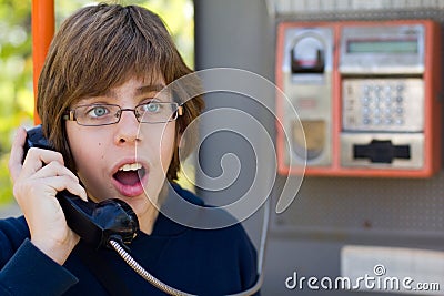 Male teenager talking on street phone