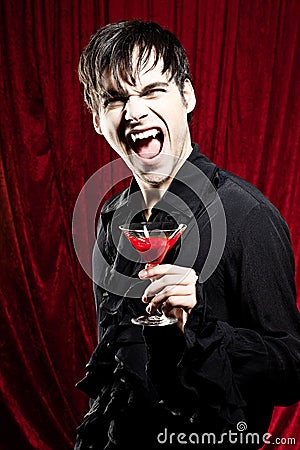 Male vampire with a bloody drink