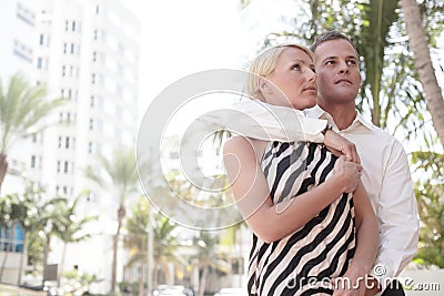 Man with arm around woman