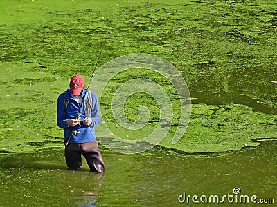 Man attaches fly to fishing line