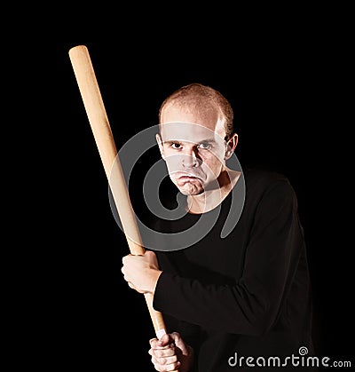 Man with baseball bat on black