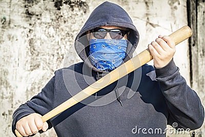 Man with a baseball bat on old wall background