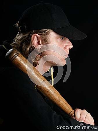 Man with baseball bat in profile.