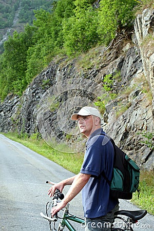Man with bike on mountain trip