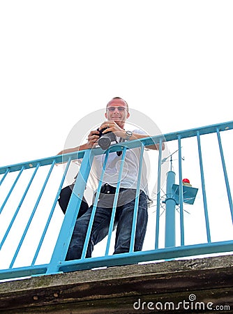 Man on bridge with camera