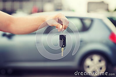 Man with car key outside