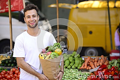 Man carrying shopping bag with organic food.